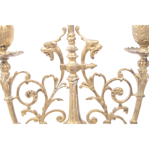 258 - A brass candelabrum / candle holder for three candles. 19th century, French origin with floral and d... 