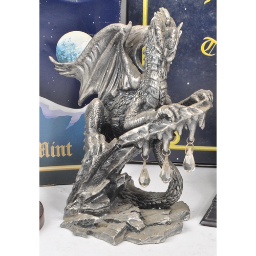 265 - Myth & Magic by The Tudor Mint - Four modern cast pewter statue dragon figurines. To include The... 