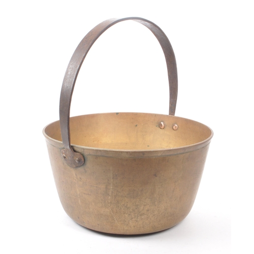 279 - A large 19th century Victorian brass jam pan. With a circular form and a large looping handle. Measu... 