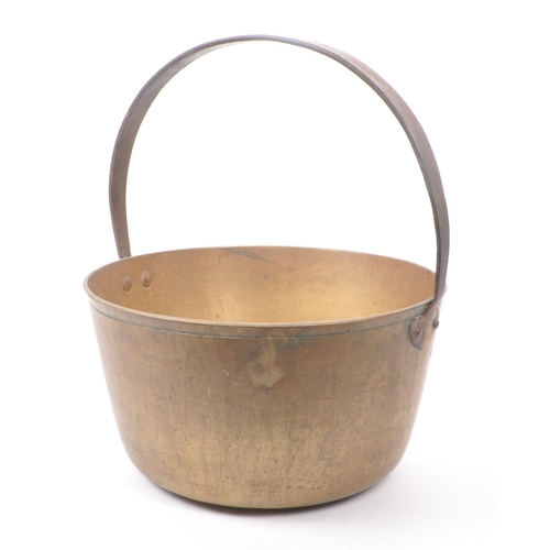 279 - A large 19th century Victorian brass jam pan. With a circular form and a large looping handle. Measu... 