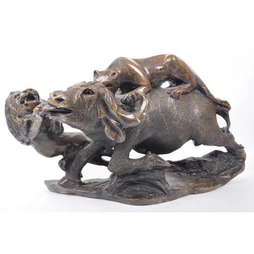 294 - A large believed South African 20th century carved soapstone sculpture of lions slaying a buffalo. T... 