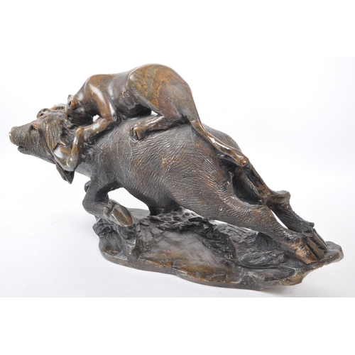 294 - A large believed South African 20th century carved soapstone sculpture of lions slaying a buffalo. T... 