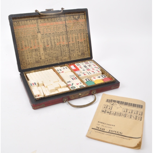 304 - A vintage mahjong game set with decorative case, 1960s-1980s approximate origin. Contains plastic ti... 