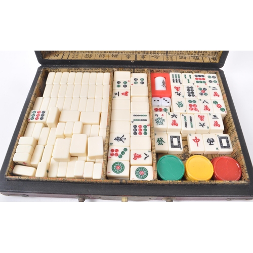 304 - A vintage mahjong game set with decorative case, 1960s-1980s approximate origin. Contains plastic ti... 