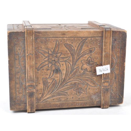 305 - A carved hardwood souvenir box lined with red imitation suede. Swiss in origin, carved with an edelw... 