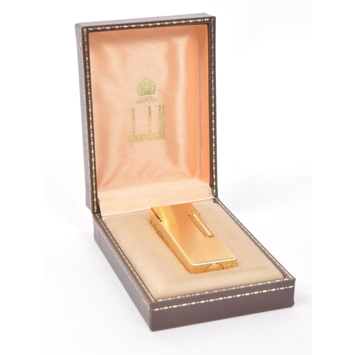 310 - Dunhill - A vintage 20th century Dunhill Rollagas rolled gold plated lighter. The lighter having eng... 