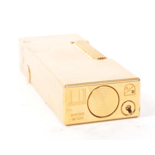 310 - Dunhill - A vintage 20th century Dunhill Rollagas rolled gold plated lighter. The lighter having eng... 