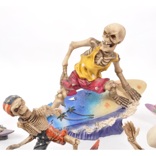 314 - A collection of eleven contemporary surfing skeleton resin figures, all depicting skeletons in vario... 