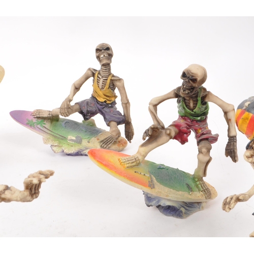 314 - A collection of eleven contemporary surfing skeleton resin figures, all depicting skeletons in vario... 