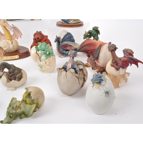 317 - A large collection of contemporary resin dragon figures, mostly depicting dragons hatching out of eg... 