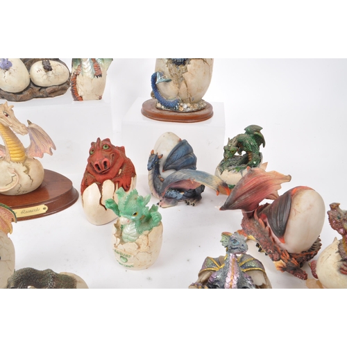 317 - A large collection of contemporary resin dragon figures, mostly depicting dragons hatching out of eg... 