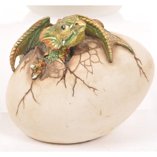 320 - Nemesis Now - A collection of nine 21st century resin dragon money boxes, all depicting dragons hatc... 