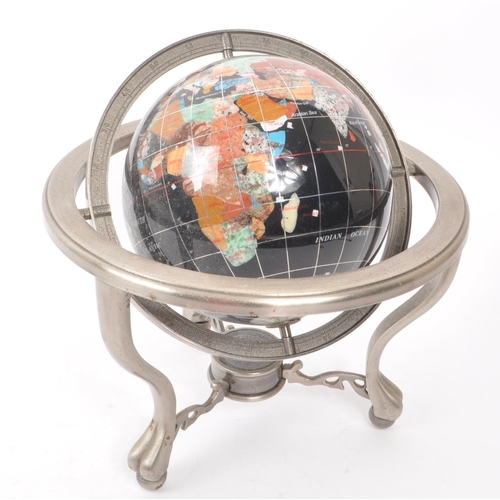 330 - A vintage 20th century gemstone inlaid desktop globe. The globe of black ground featuring precious s... 