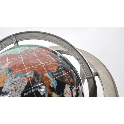 330 - A vintage 20th century gemstone inlaid desktop globe. The globe of black ground featuring precious s... 