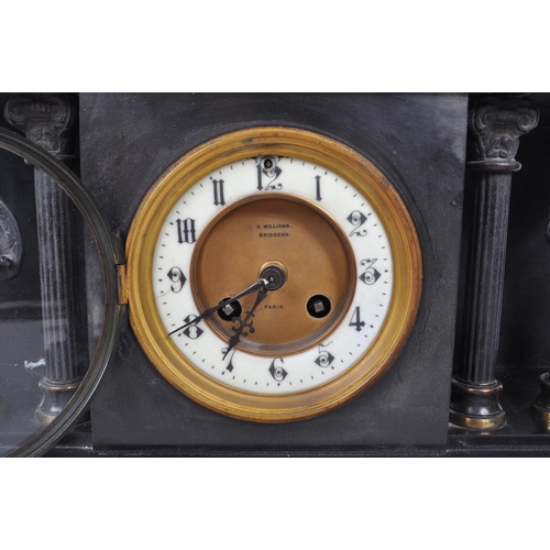 345 - An antique 1910 French slate mantel clock garniture, in three pieces. The slate clock features an en... 