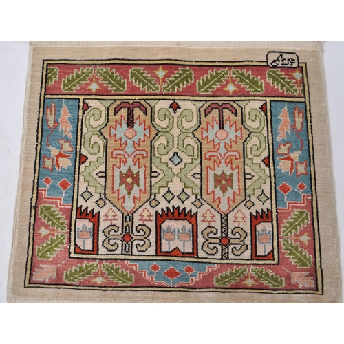 346 - Two vintage 20th century miniature Persian silk rugs / table mats. The larger example having deep bl... 