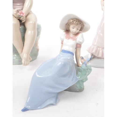 37 - Nao - Lladro - Six late 20th century Spanish lady figurines, comprising of a girl in pink sat on a r... 