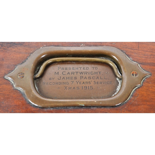 372 - A vintage 1915 mahogany carved jewellery box, inlaid with a brass handle and plaque that reads 'Pres... 