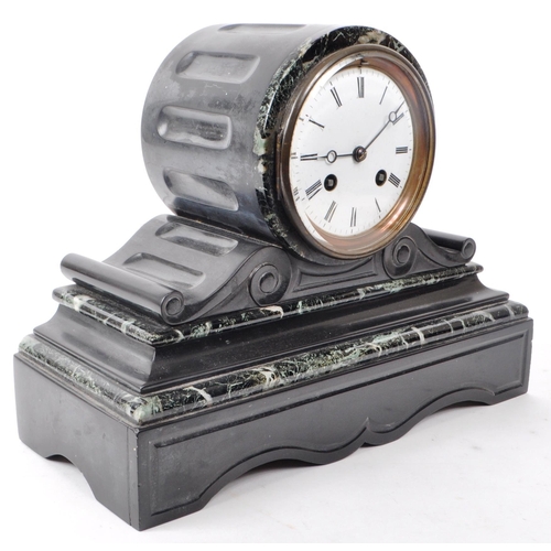 389 - A Victorian 19th century black slate and green marble mantel clock with key. Having an 8 day movemen... 