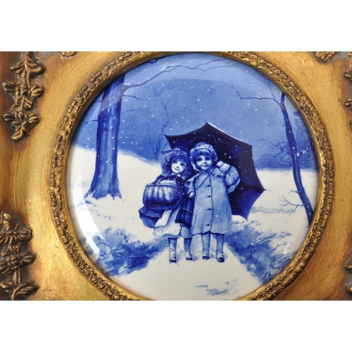 391 - Two vintage 20th-century framed Doulton-style blue / white porcelain plaques, both depicting two chi... 