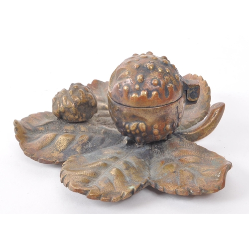 392 - A vintage 20th-century brass acorn-shaped inkwell, featuring two acorns sat upon an oak tree leaf, w... 