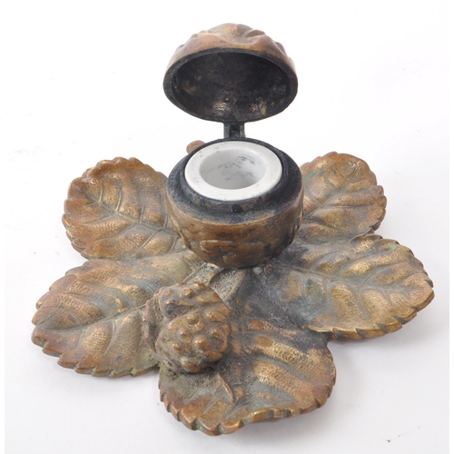 392 - A vintage 20th-century brass acorn-shaped inkwell, featuring two acorns sat upon an oak tree leaf, w... 