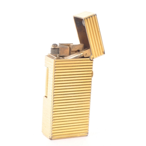 395 - Dunhill - A vintage 20th century Dunhill Rollagas miniature gold plated lighter. The lighter having ... 