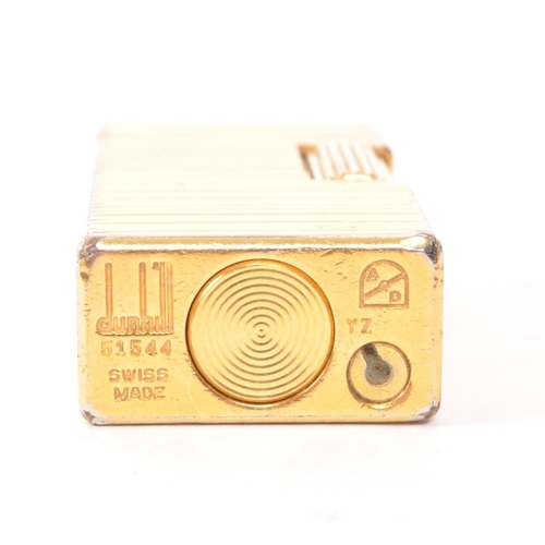 395 - Dunhill - A vintage 20th century Dunhill Rollagas miniature gold plated lighter. The lighter having ... 