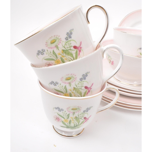 403 - Susie Cooper - A collection of mid-century bone china tea service pieces, in 'Romance' pink. Featuri... 