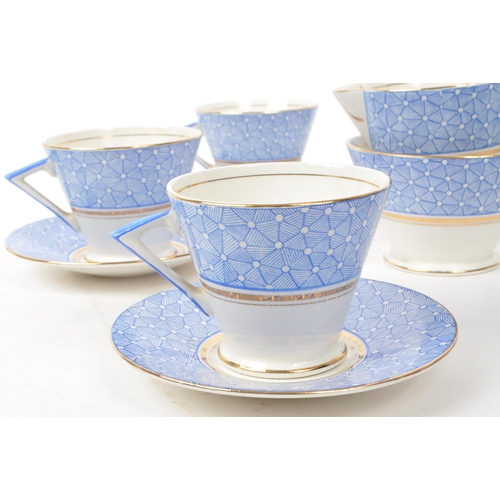 411 - A collection of vintage early 20th-century art deco porcelain tea service pieces, in the style of Sh... 