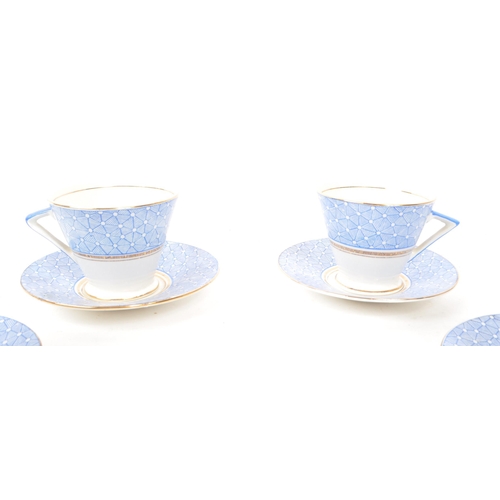 411 - A collection of vintage early 20th-century art deco porcelain tea service pieces, in the style of Sh... 