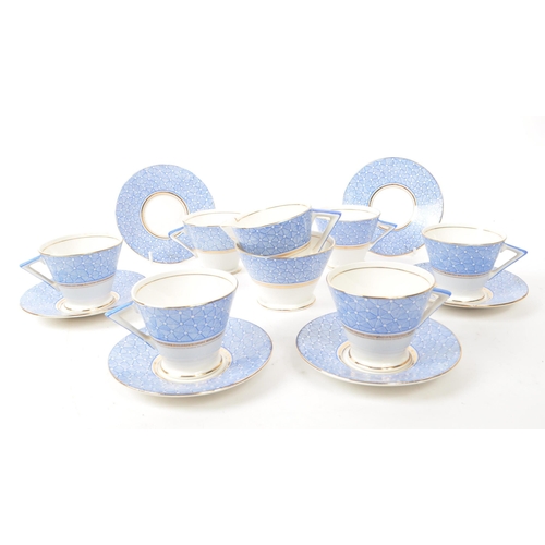 411 - A collection of vintage early 20th-century art deco porcelain tea service pieces, in the style of Sh... 