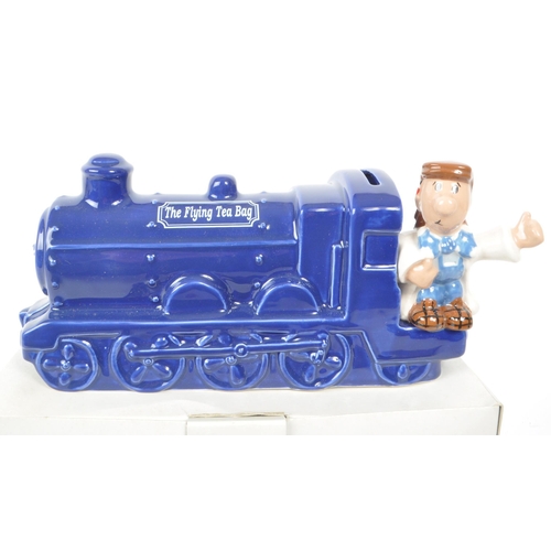 412 - Wade - Tetley - Two vintage Wade for Tetley Tea ceramic money box figures. Each figure in a deep blu... 