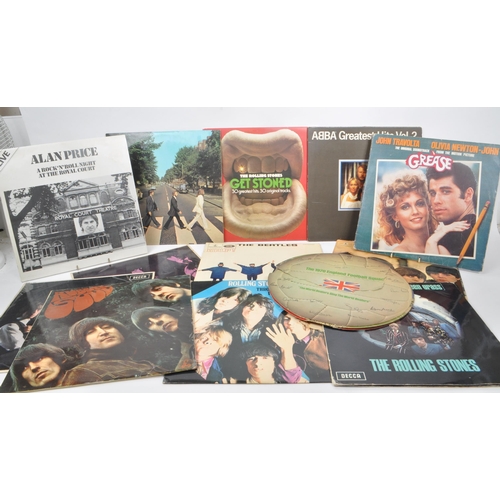 443 - A collection of thirteen vintage 20th century vinyl records, featuring artists such as The Beatles, ... 