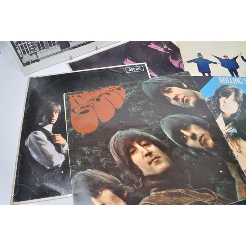 443 - A collection of thirteen vintage 20th century vinyl records, featuring artists such as The Beatles, ... 