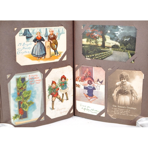 470 - Christmas greetings themed poscards early to mid 20th century. Collection of 348 in a Victorian albu... 