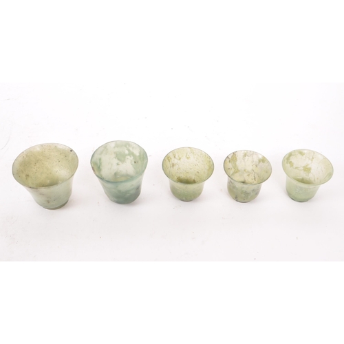 53 - Five early 20th century Chinese hardstone cups, slightly varying in sizes. In a light green colour, ... 