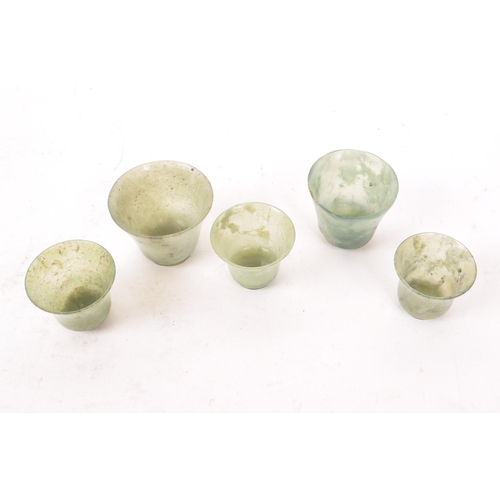 53 - Five early 20th century Chinese hardstone cups, slightly varying in sizes. In a light green colour, ... 