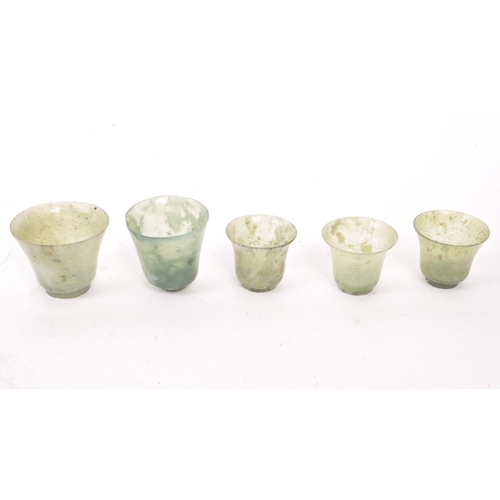 53 - Five early 20th century Chinese hardstone cups, slightly varying in sizes. In a light green colour, ... 