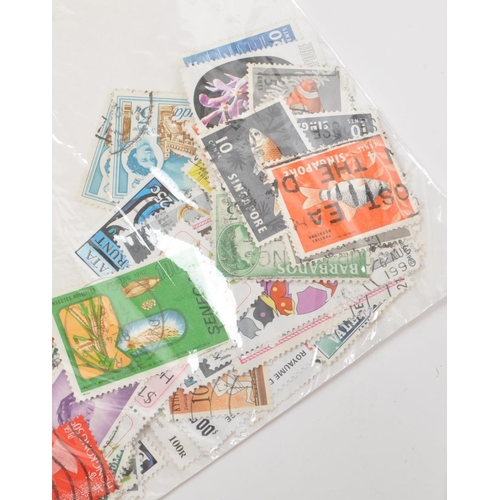 543 - A collection of 20th century British and Foreign kiloware loose postage stamps. The collection featu... 