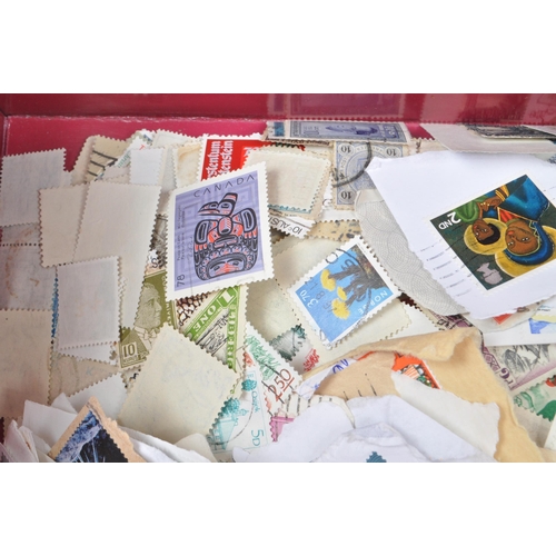 545 - A collection of 20th century British and Foreign kiloware loose postage stamps. The collection featu... 