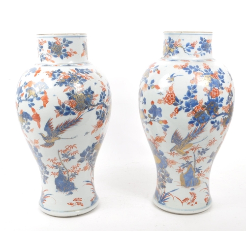 59 - A pair of tall 19th century Chinese glazed vases (1 AF). Traditional blue and red flora and fauna de... 