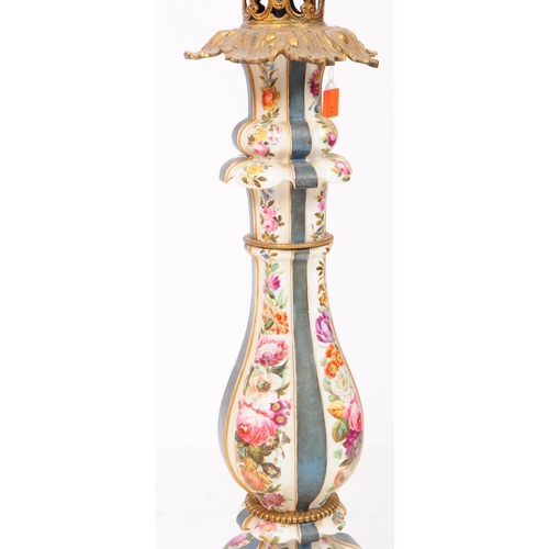 60 - A tall porcelain table lamp with ornate metal head and pale pink lampshade. The porcelain body is de... 