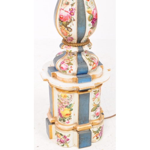 60 - A tall porcelain table lamp with ornate metal head and pale pink lampshade. The porcelain body is de... 