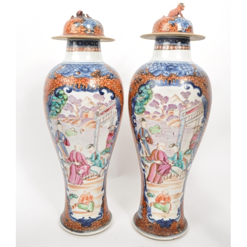 69 - A pair of Chinese export Mandarin Palette baluster vases with covers. Hand painted in blue and orang... 