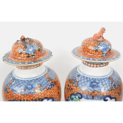 69 - A pair of Chinese export Mandarin Palette baluster vases with covers. Hand painted in blue and orang... 