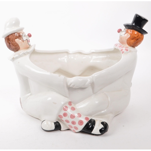 74 - A mid 20th century Italian ceramic clown plant pot, featuring a pair of clown figures in the shape o... 