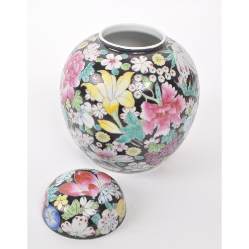 77 - An early 20th century Nianqian Zhilong ginger jar. Hand painted with floral pattern agains a black g... 