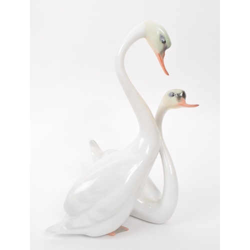 97 - Herend - Two vintage 20th century Herened model 05193000C and 05192000C porcelain mute swan figures.... 