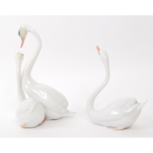 97 - Herend - Two vintage 20th century Herened model 05193000C and 05192000C porcelain mute swan figures.... 